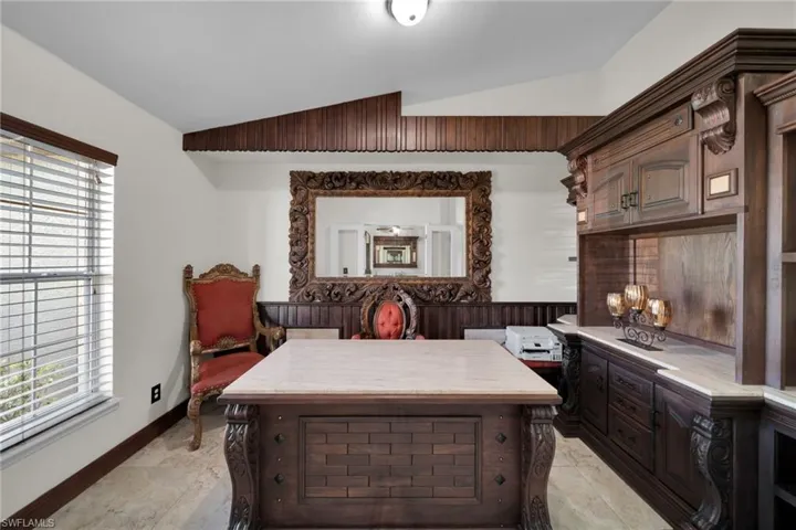 Bedroom with lofted ceiling and baseboards