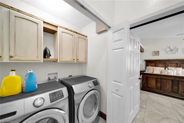 Laundry room featuring washing machine and dryer and cabinet space