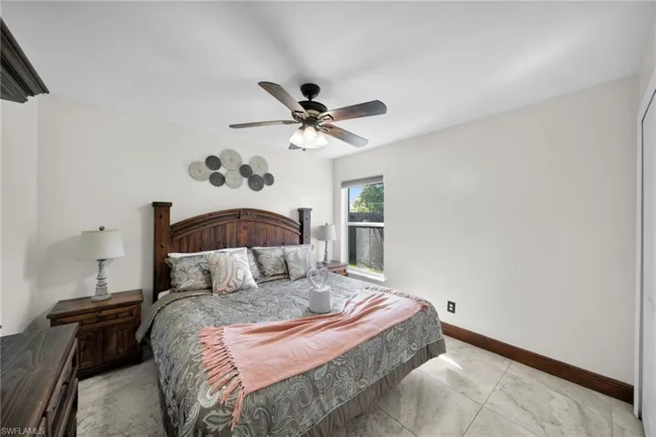 Bedroom with a ceiling fan and baseboards