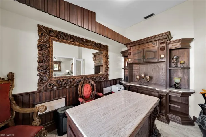 Office with wainscoting and wooden walls