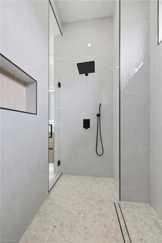 Full bathroom with a marble finish shower