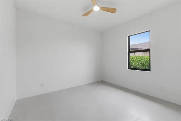 Spare room featuring finished concrete floors and a ceiling fan