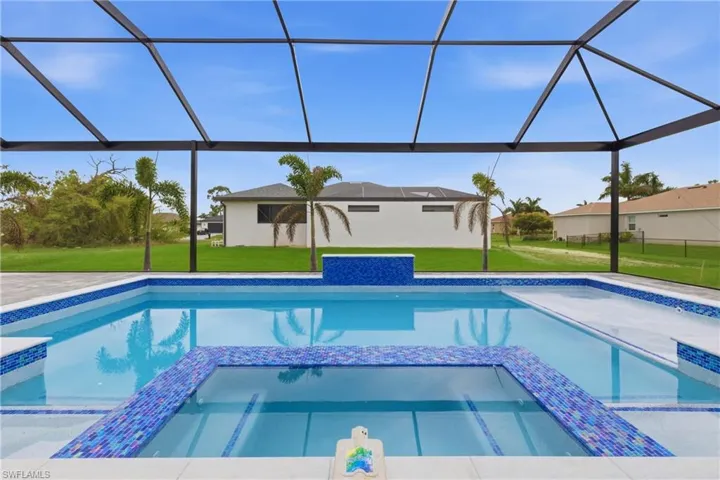 Integrated pool / hot tub featuring a yard, a sunroom, and a lanai