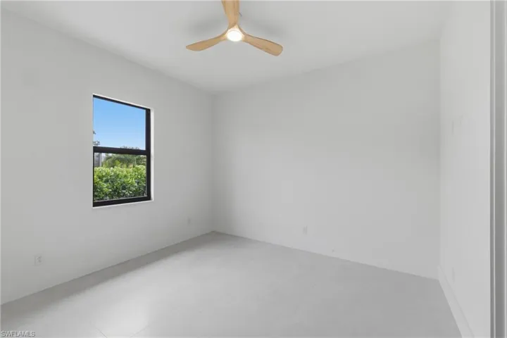 Spare room featuring concrete flooring and ceiling fan