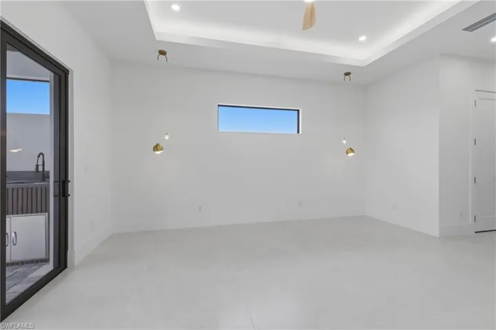 Spare room featuring ceiling fan, a raised ceiling, and recessed lighting