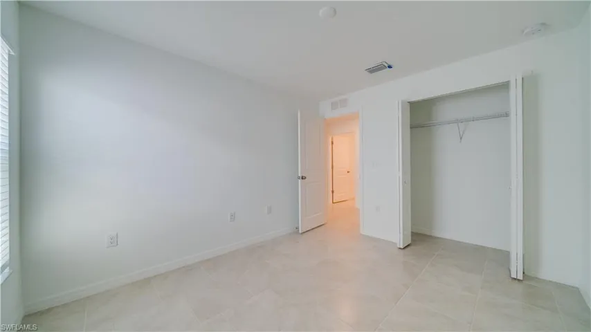 Unfurnished bedroom with a closet and baseboards