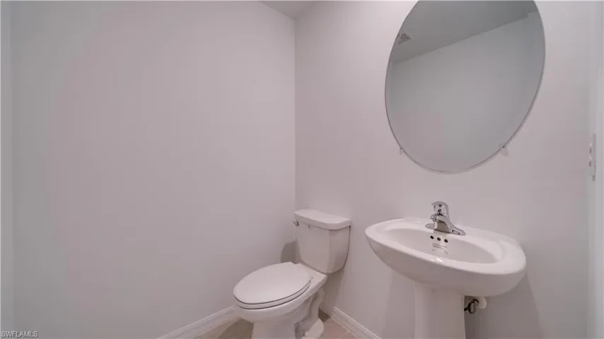 Bathroom with toilet and baseboards