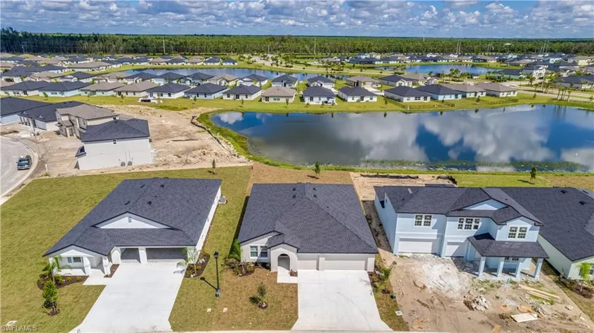 Aerial perspective of suburban area with a nearby body of water