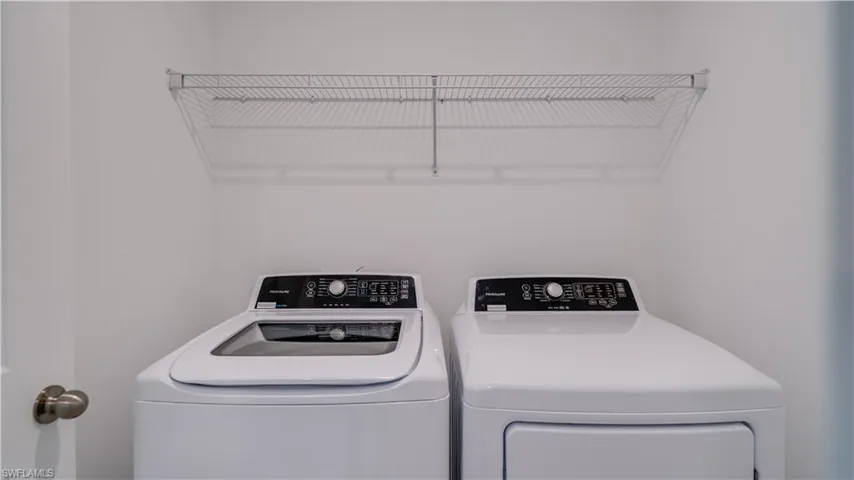 Laundry area featuring washing machine and clothes dryer