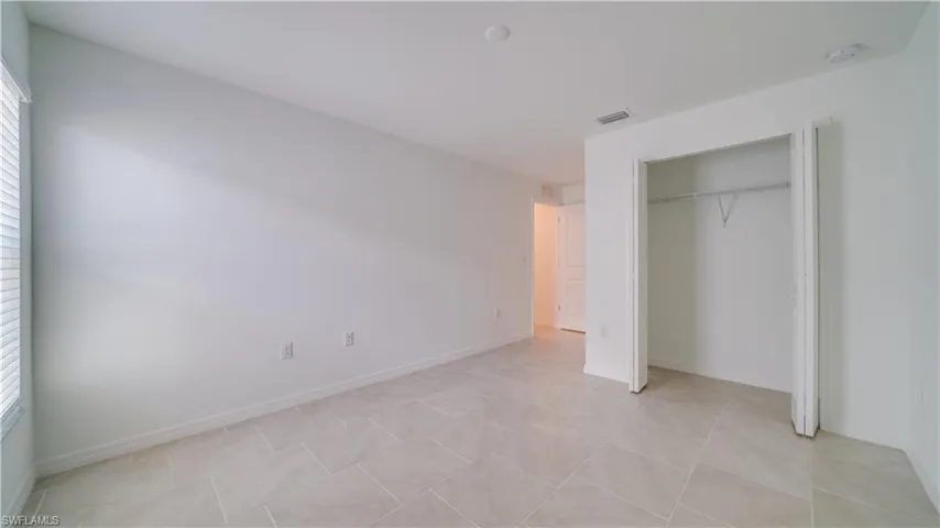Unfurnished bedroom featuring baseboards and a closet