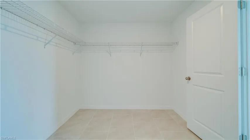 Walk in closet featuring light tile patterned floors