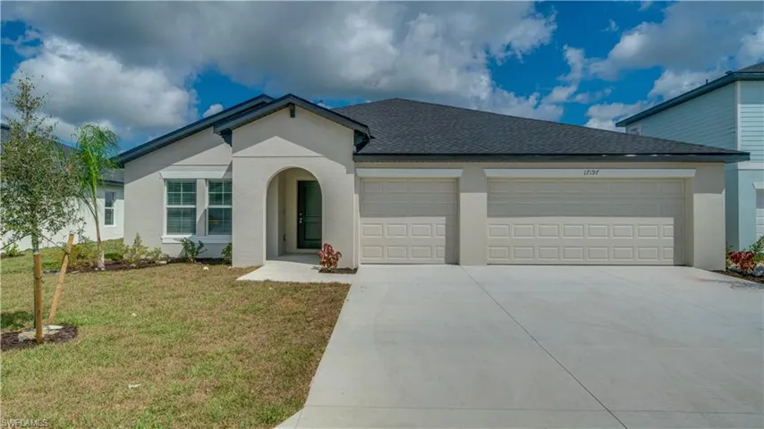 View of front of house with an attached garage, a front yard, concrete driveway, a shingled roof, and stucco siding