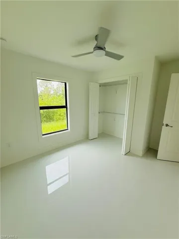 Unfurnished bedroom featuring ceiling fan and a closet