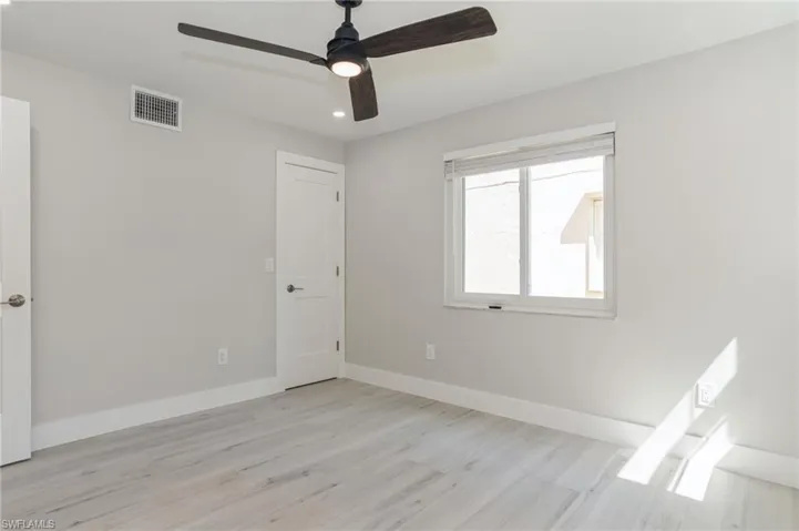 Empty room featuring light wood-style flooring, a ceiling fan, and recessed lighting