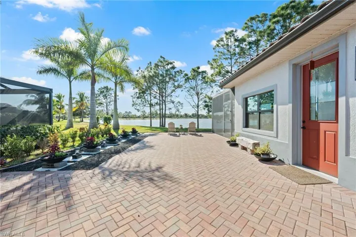 View of patio / terrace featuring glass enclosure and a water view
