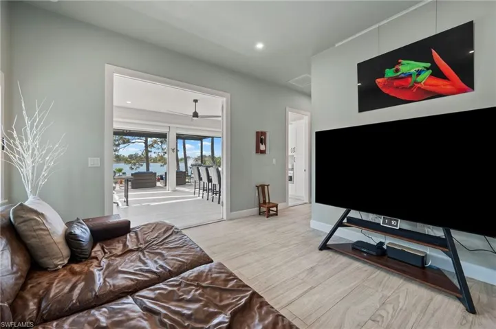Living area with light wood-style flooring, recessed lighting, and a ceiling fan