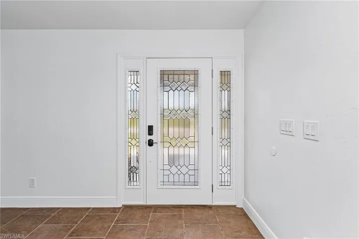 Entrance foyer featuring dark tile flooring