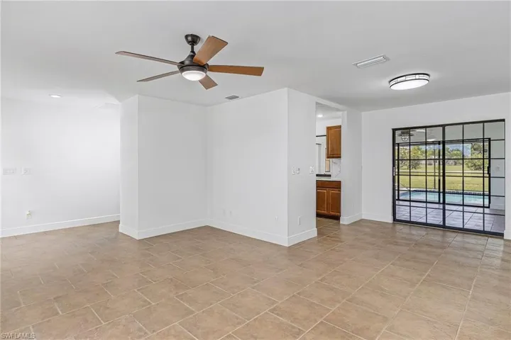 Tiled empty room featuring ceiling fan