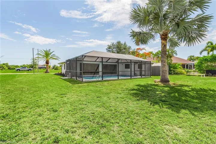 View of yard featuring glass enclosure