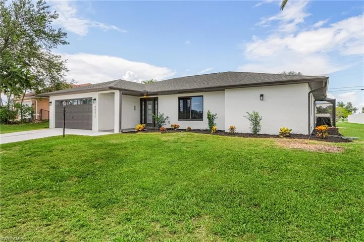 View of front facade with a front yard and a garage