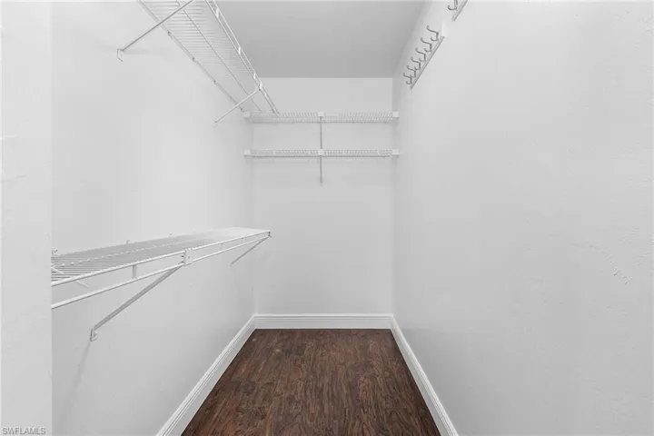 Walk in closet featuring hardwood / wood-style floors
