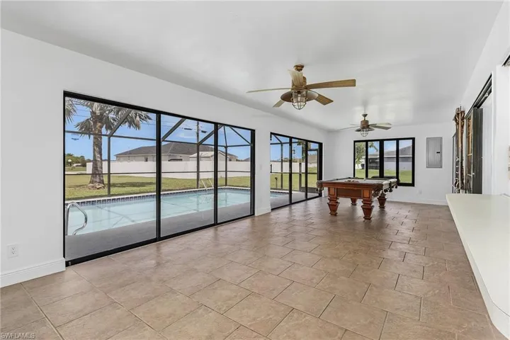 Rec room with billiards, ceiling fan, and light tile floors