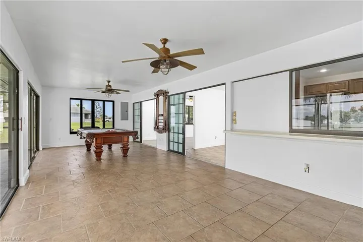 Recreation room with billiards, ceiling fan, and light tile floors