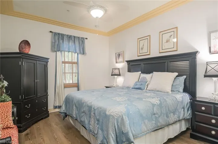 Bedroom featuring hardwood / wood-style floors, ceiling fan, and crown molding