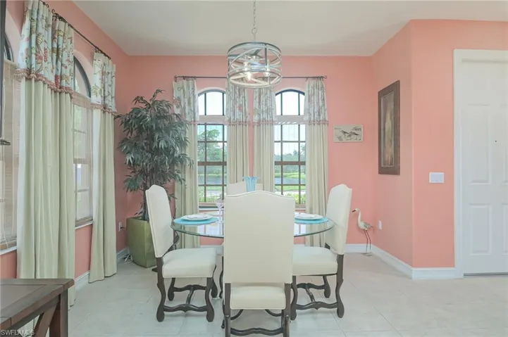 Tiled dining space with an inviting chandelier