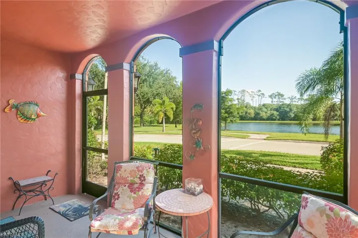 Sunroom featuring a water view