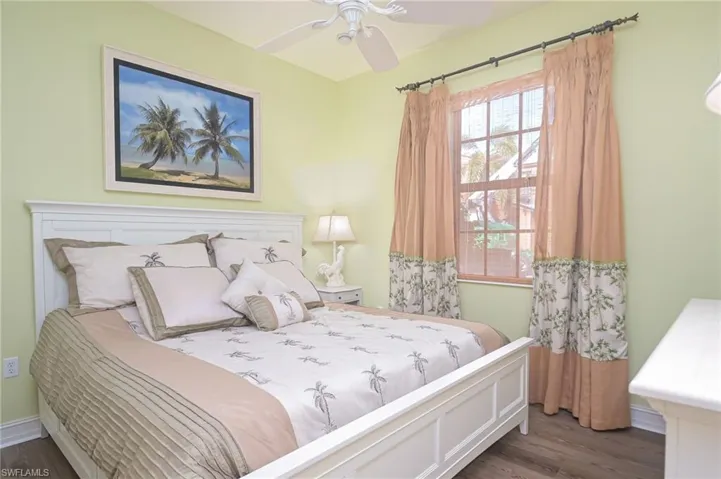 Bedroom featuring ceiling fan and dark hardwood / wood-style flooring