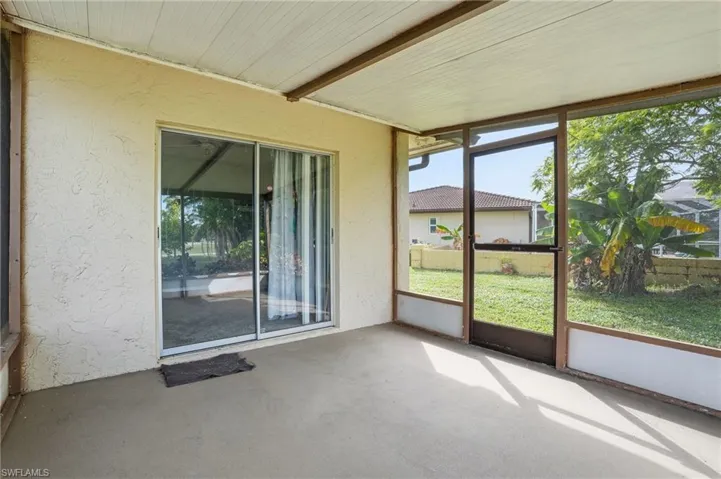 Unfurnished sunroom featuring beam ceiling