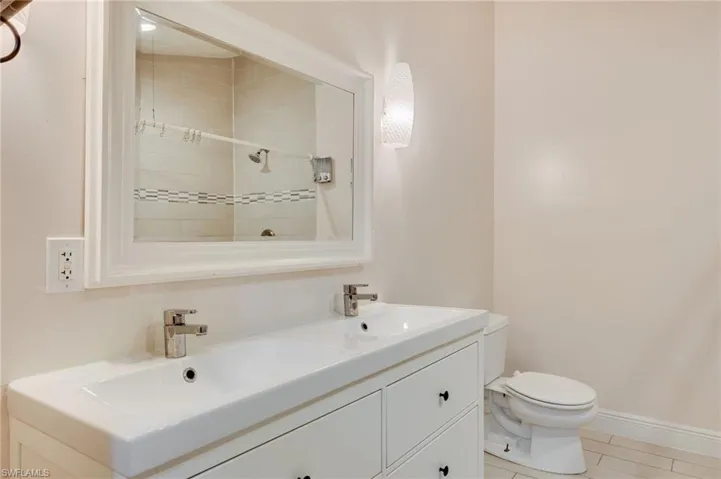 Bathroom with double vanity and a shower