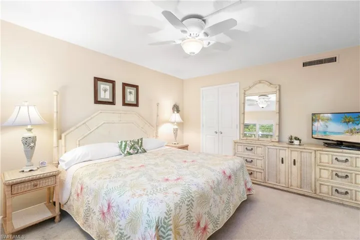 King sized bed in primary, plantation shutters on windows throughout