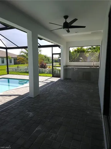 View of swimming pool with a patio and ceiling fan