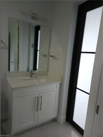 Bathroom with vanity and tile patterned flooring