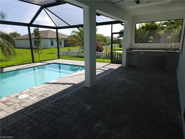 View of swimming pool featuring a patio and a yard