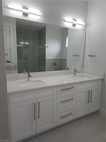 Bathroom with tile patterned flooring and double sink vanity