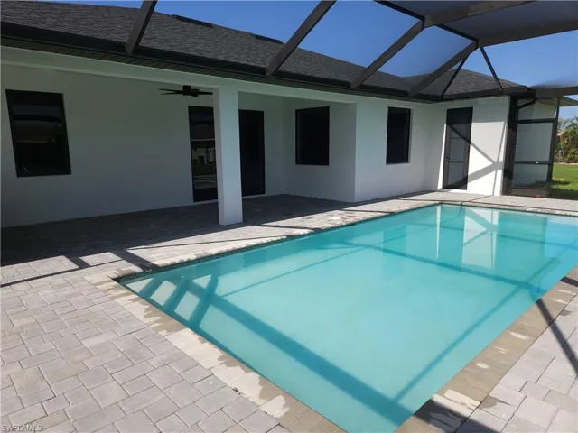 View of pool featuring ceiling fan, a patio area, and a lanai