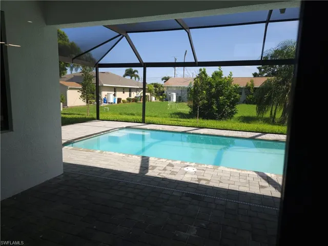 View of swimming pool with a patio and a yard