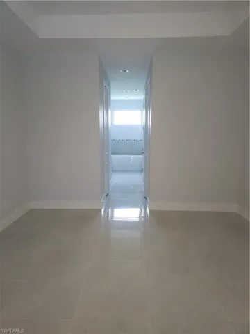 Hall with light tile patterned floors