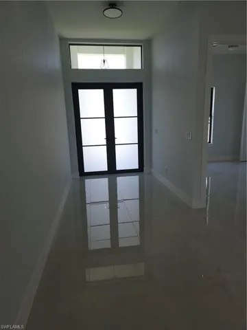 Doorway featuring plenty of natural light, french doors, and tile patterned floors