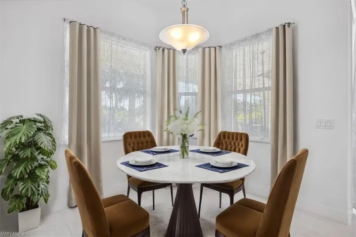 Breakfast area with light tile patterned floors Virtually Staged
