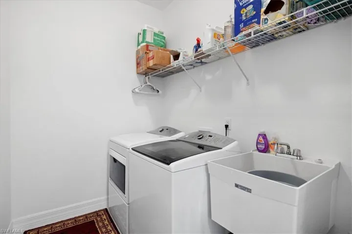 Laundry room featuring separate washer and dryer and baseboards