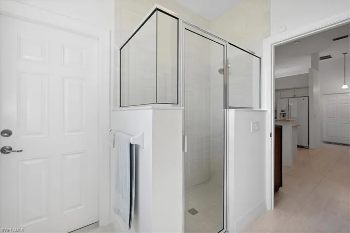 Full Guest bath featuring a stall shower and light tile patterned flooring