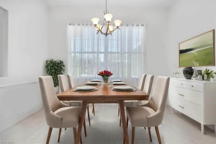 Formal Dining space with healthy amount of natural light and a chandelier virtually staged