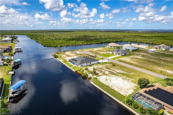 Birds eye view of property with a water view