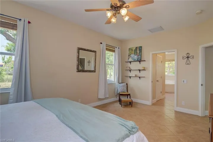 View of primary bedroom looking into en suite bathroom and two walk in closets.