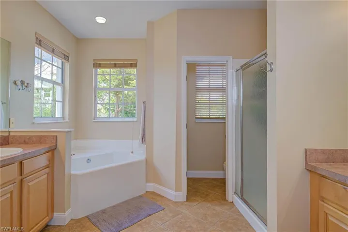 His and hers sinks, soaking tub and walk in shower.