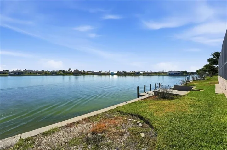 Backyard with cement seawall and dock